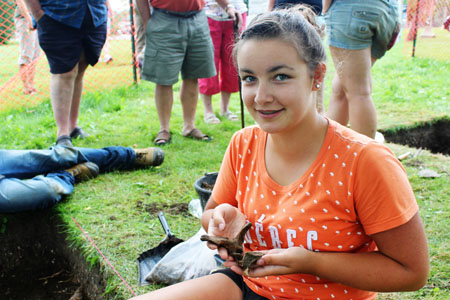 Young Adult participant holding artifacts. Participant holding artifact